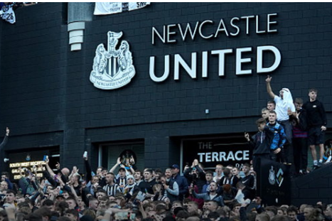 Newcastle United fans celebrate in front of the stadium